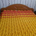 Bright yellow blanket on the bed