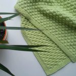 Green plaid with an unusual pattern of knitting
