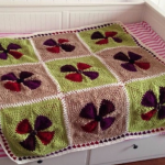 Crochet flower plaid made from triangular motifs