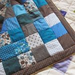 Blue quilt of squares on patchwork technology
