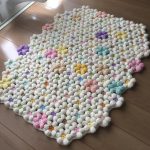 Plaid rug made of delicate flowers in pastel colors