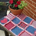 A small blue-red rug on a street bench