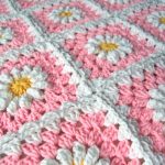 Delicate crocheted daisy plaid