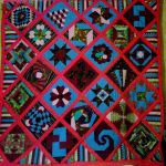 Handmade quilt in patchwork technique with geometric shapes