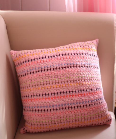 Pink pillow with bright stripes