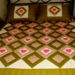 Elegant blanket with diamonds and hearts on a large bed