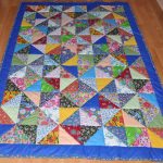 Blue blanket with colorful triangular inserts
