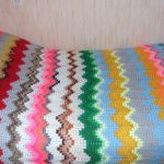 Bright and unusual knitted plaid of multi-colored yarn residues