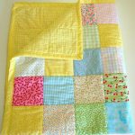 Bright yellow blanket cover with multi-colored patchwork inserts