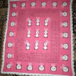 Openwork pink blanket with bunnies for a little girl