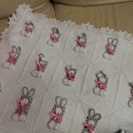 White openwork blanket with gray hares