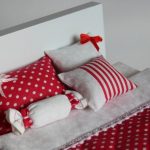 White polka dots on a red background for the doll bed