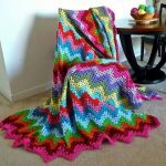 Large and bright crocheted plaid from different threads