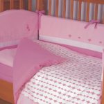 Pink bed set for the girl in the crib