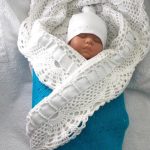 Knitted openwork envelope for baby