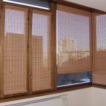 Wooden curtains on the glazed balcony