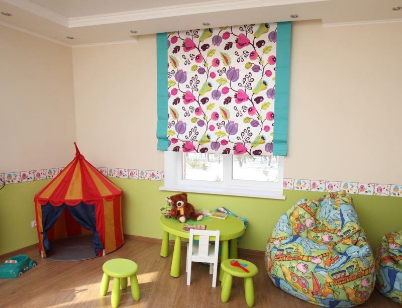 Bright floral ornament on the roman blinds in the children's room