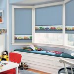 Bay window in the nursery with roller blinds
