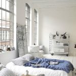 Loft-style bedroom interior with a sleeping mattress instead of a bed