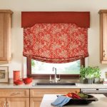 Red kitchen roller blinds in the kitchen on the ledge