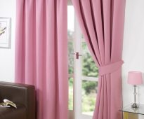 Saturated pink curtains of thick fabric in the living room