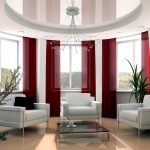 Ceiling maroon curtains on large windows in an oval room