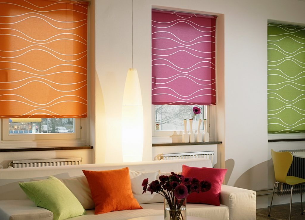Multicolored roller blinds in the living room interior
