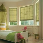 Roman curtains in the children's room bay window