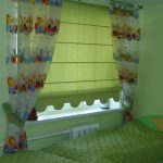 Green bedspread on baby bed