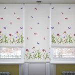 Small butterflies on a white roller blind