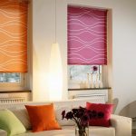 Multicolored roller blinds on the windows of the living room