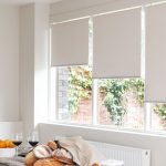 White roller blinds on the large kitchen window