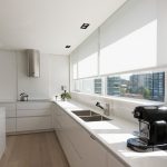White kitchen design with large window