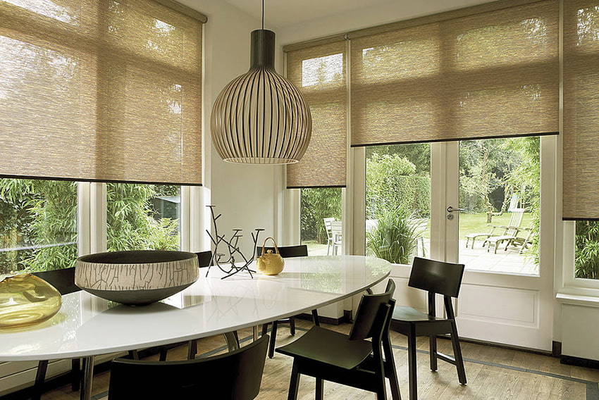 Rolled curtains of natural material in the interior of the kitchen