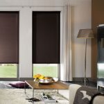Living room design with dark roll-up curtains