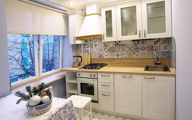 The interior of the kitchen in the style of Provence with roller blinds