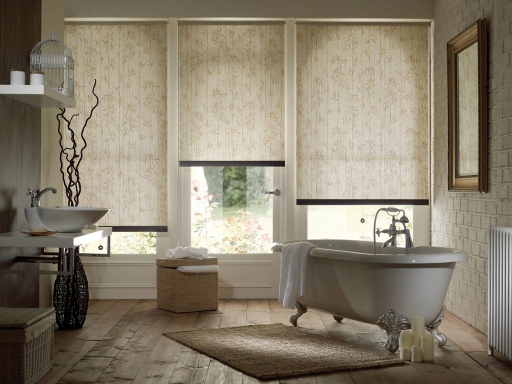 Interior of a spacious bathroom with roller blinds on the windows