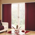 Fabric burgundy blinds on a large window
