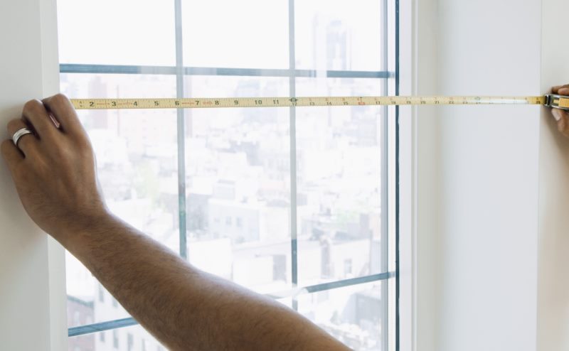 Measurement of a window opening with a metal tape measure with your own hands