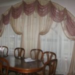 Arched window with beautiful curtains on a flexible cornice