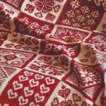 White and red knitted cover from motifs with different patterns