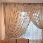 White and beige curtains with kitchen grab