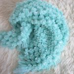 Turquoise plaid of pompons for baby or baby