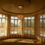 Large windows of a country house require special flexible ceiling mounting.