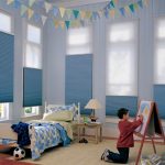 Blue curtains in the children's room of the young artist
