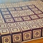 Beautiful blanket on a large bed of knitted two-color elements