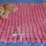 Square pink plaid of pompons