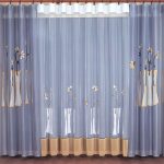 Delicate blue curtain with flowers
