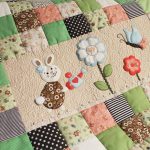 Blanket for the baby from different pieces and with applications in the middle