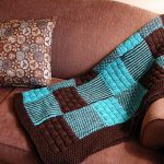 Brown plaid with blue knitting needles from squares
